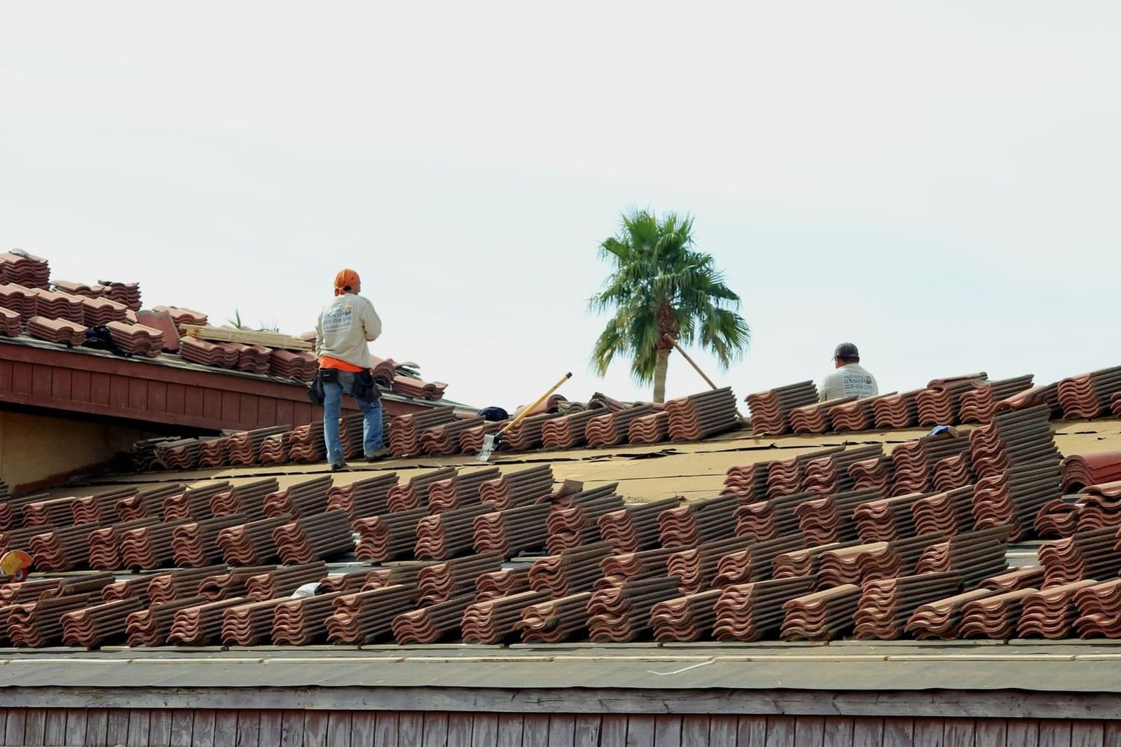 Roofer working on a clay tile roof
