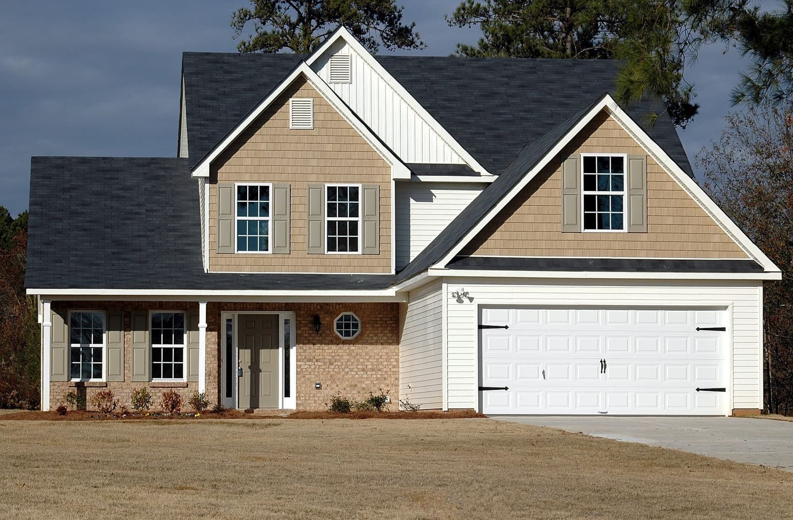 Two-story house with dark shingle roof and garage