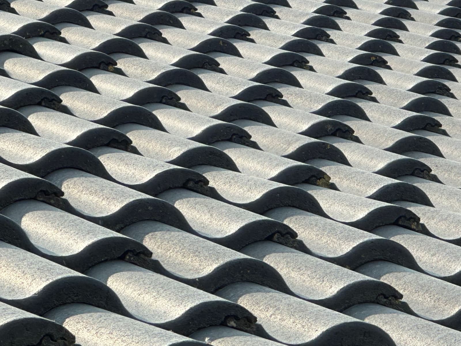 Gray concrete roof tiles close up