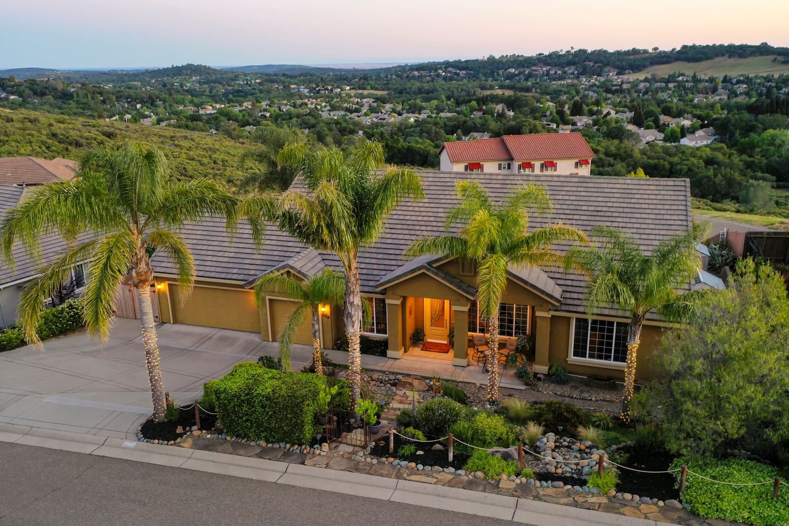Aerial view of house with shingle roof and trees