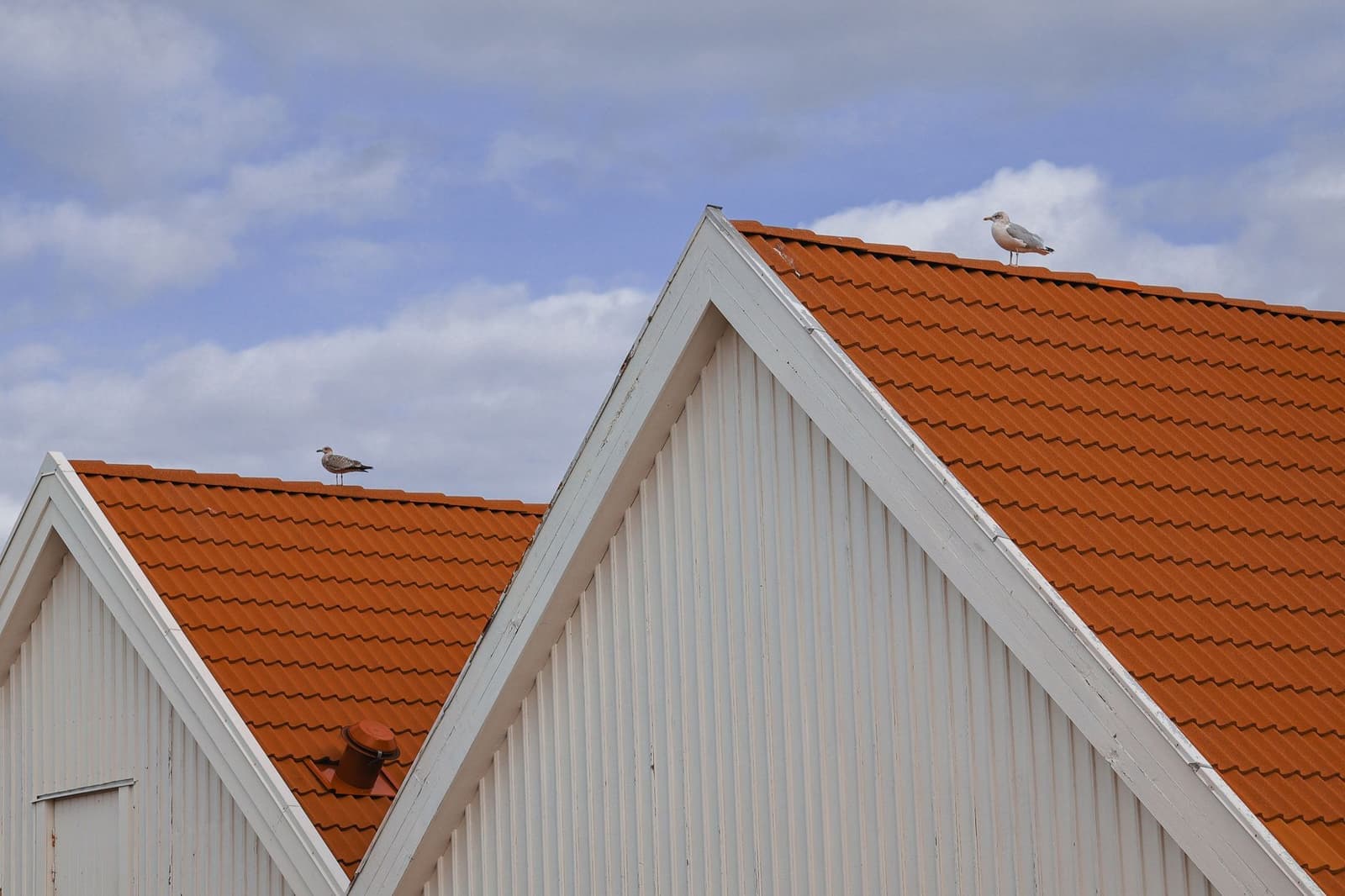 Orange tile roof gables on white building