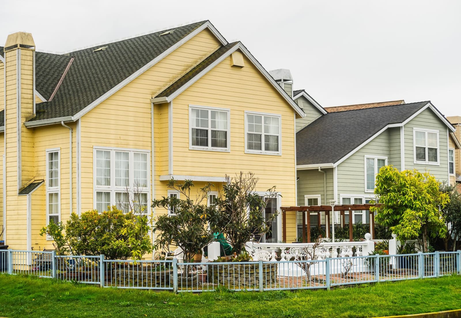 Yellow house with gray shingle roof