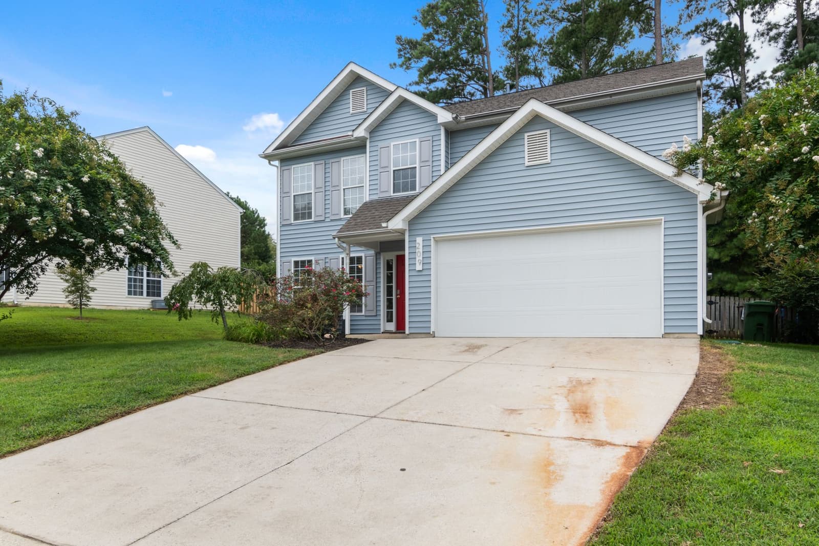 Two-story house with garage and shingle roof