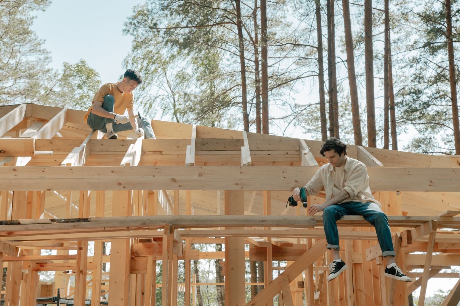 Two workers on a timber roof frame