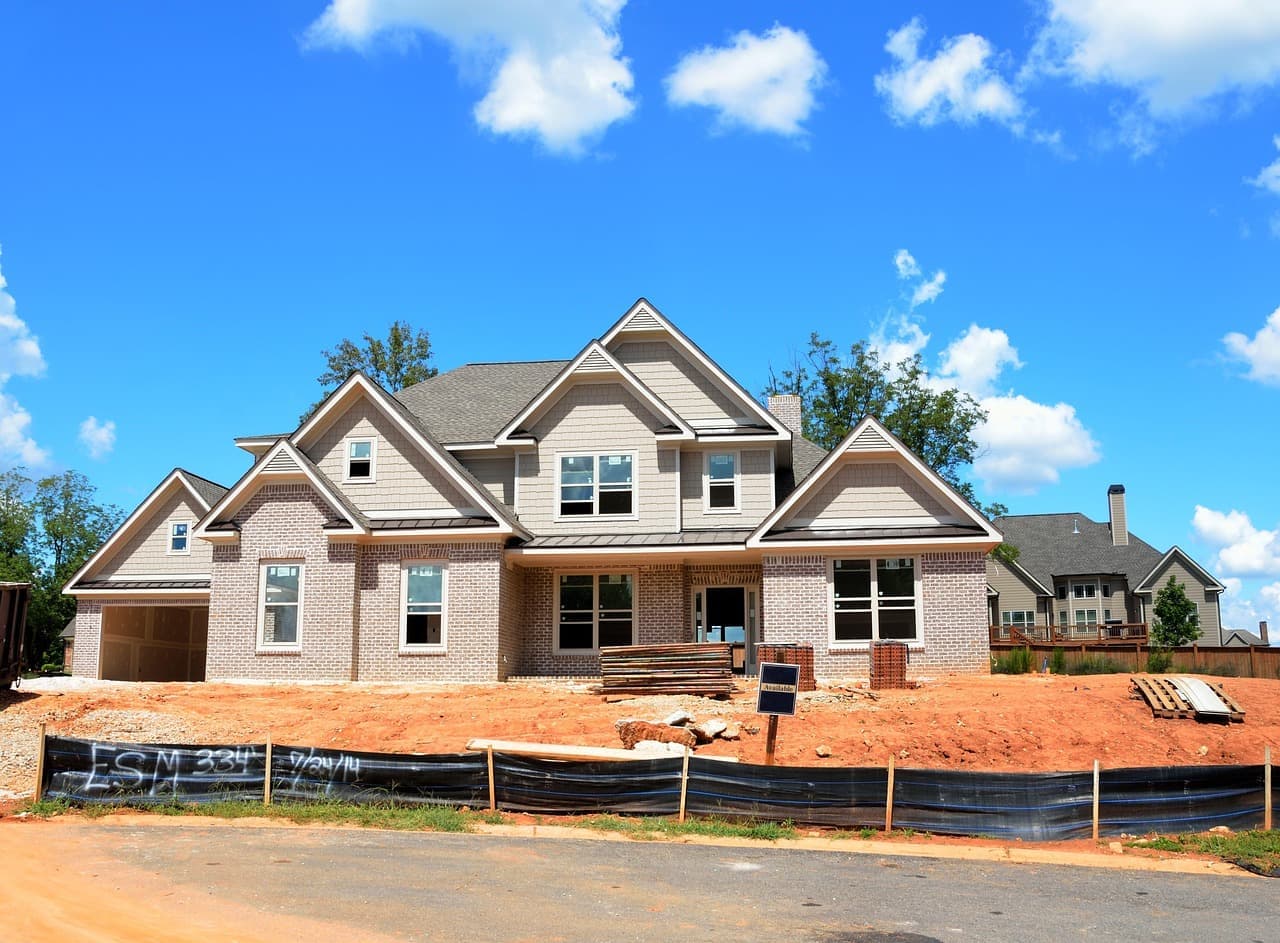 New house under construction with shingle roof