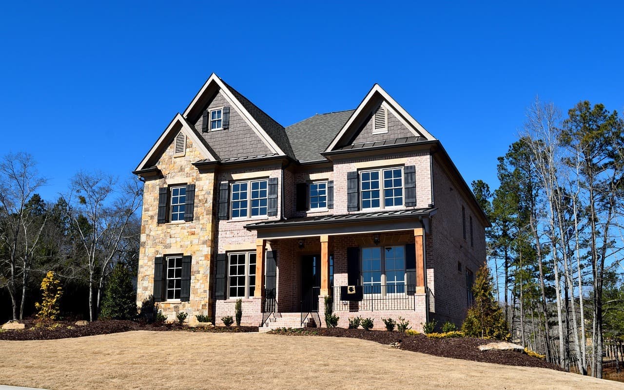 Stone and siding house with shingle roof